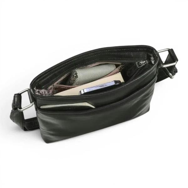 A black leather belt bag shown open, displaying its interior compartments, zippered pockets, and silver-tone metal hardware, with a phone and wallet inside, on a white background.