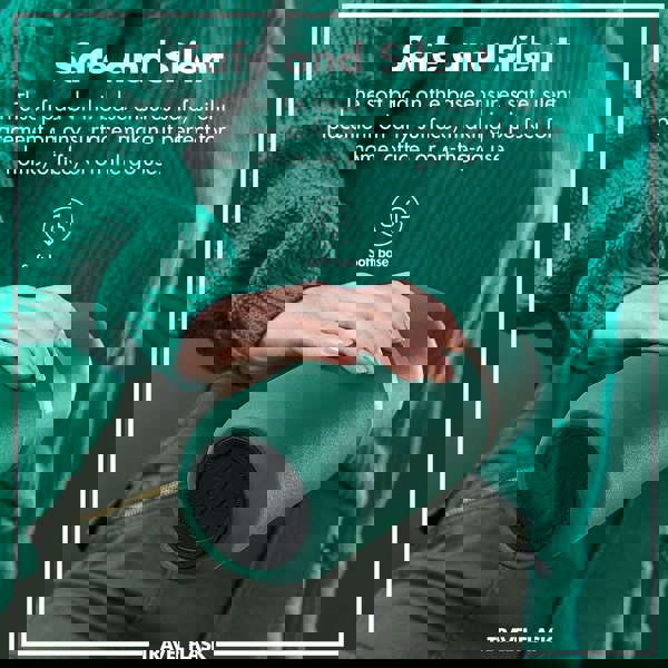 A hand holds a green travel flask with a soft base in front of a person in a green sweater and pants. Text reads Safe and Silent The soft pad on the base ensures safe silent placement on any surface making it perfect for home office or on-the-go use. Soft base TRAVEL FLASK.