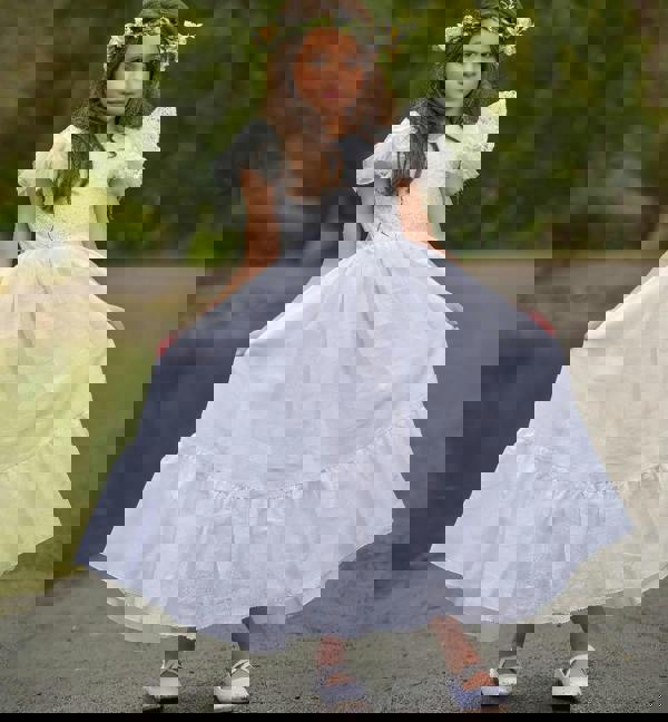 young girl holding a dress
