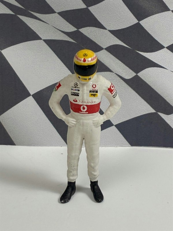 a toy figure of a race car driver
