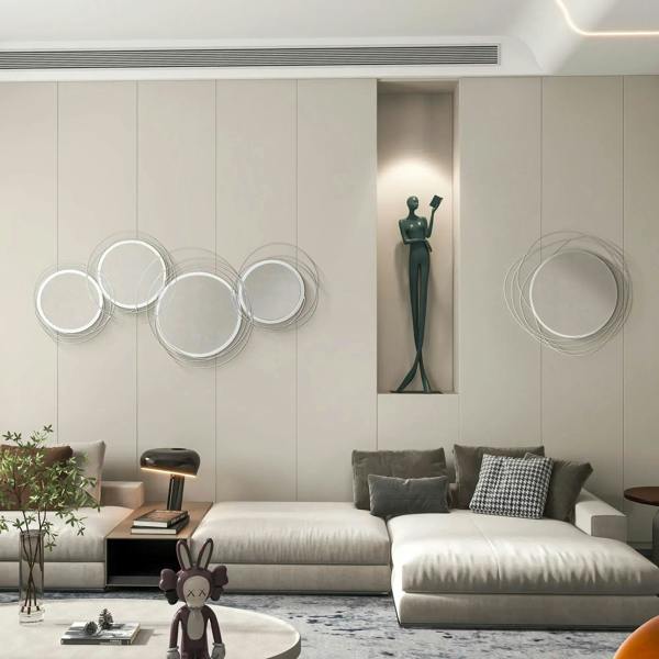 Silver round wall mirrors with abstract metal wire loop frames arranged on wall