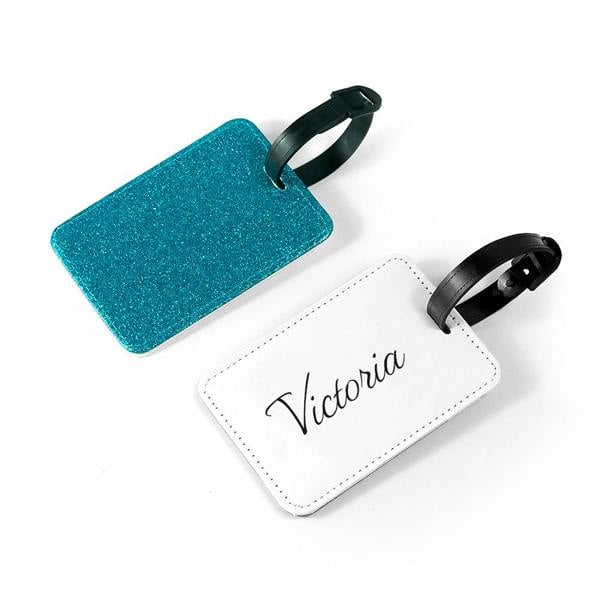 Personalised blue glitter school bag tag showing the sparkling blue front and white custom-printed back with the name Victoria