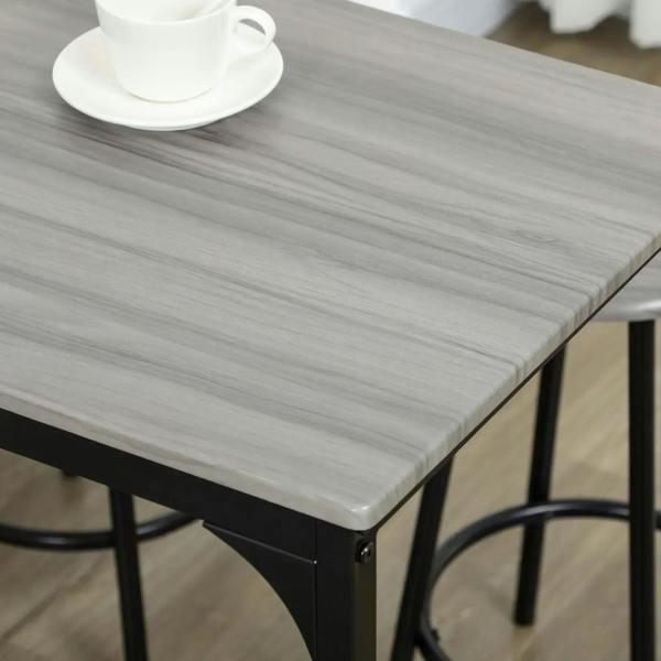 Grey wood-look bar table top corner with black metal edge and leg