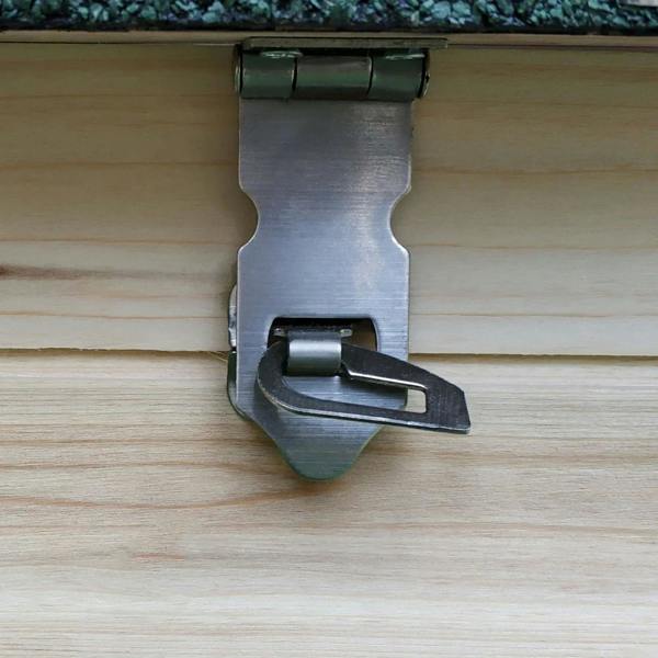 Metal latch and hasp on a wooden coop panel