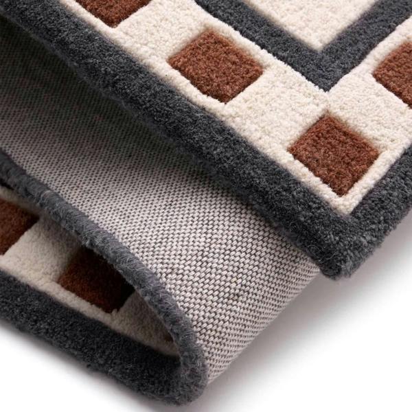 Close-up of a textured rug with geometric pattern on a white background