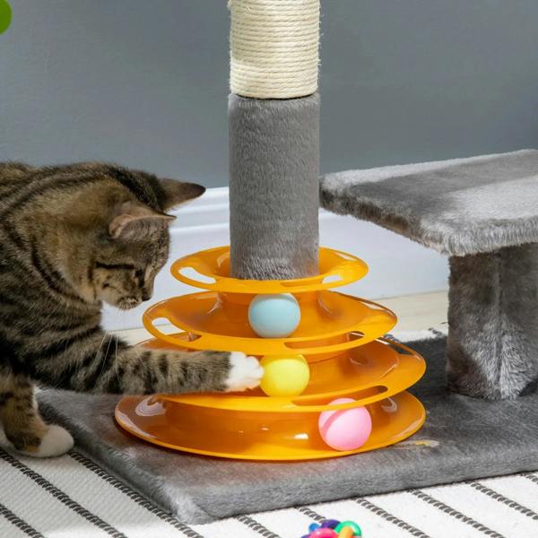 Grey cat tree tower with orange ball toy layers and hanging ball; kitten playing