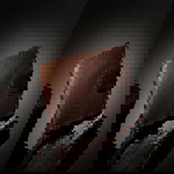 Brown leather wallet on a dark background