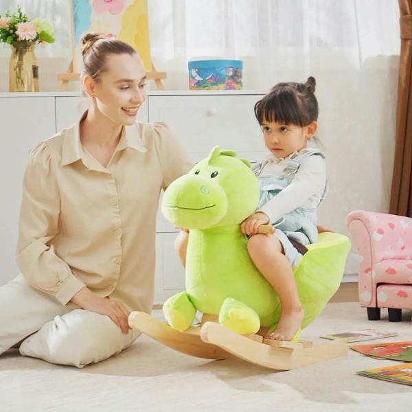 Green plush dinosaur ride-on rocking horse with padded seat and wooden rockers