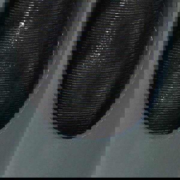 Sleek gray electric water feature with a smooth, rounded design and textured black water flow, creating a calming ambiance