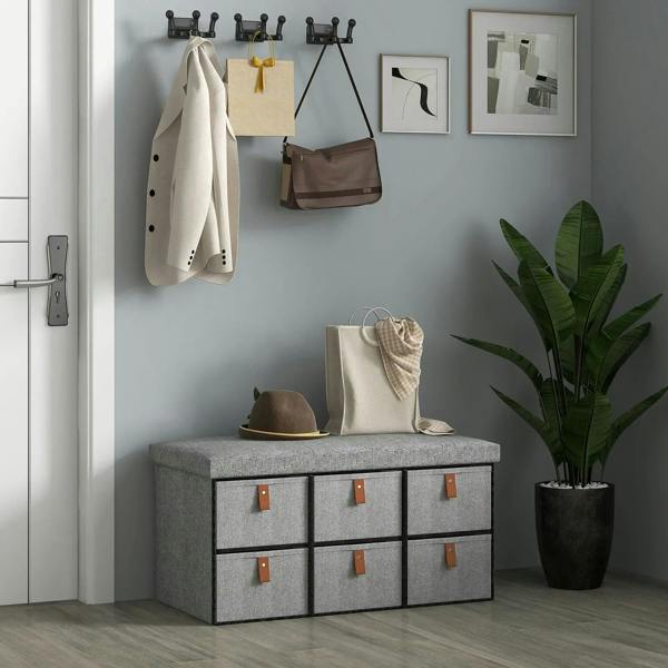 Light gray shoe storage bench with cushion and six fabric drawers