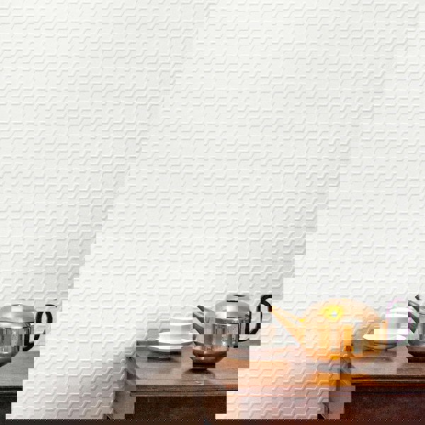 Buzz white flock on white textural wallpaper with brass teapot and white porcelain tea cup