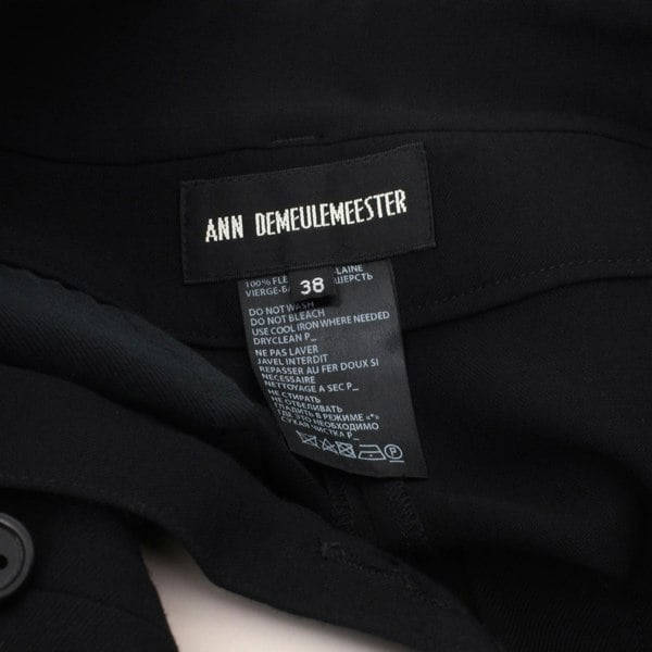 Ann Demeulermeester finely woven black wool trousers
High waisted trousers with crossover tab to waistline
Button fastening with gently tapered leg
