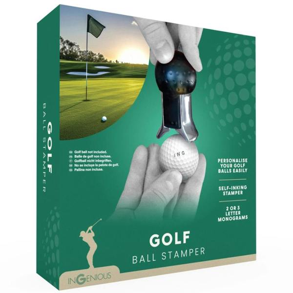 The Golf Ball Monogram Stamper packaging in green, showing a golf course landscape in the background. A pair of hands are shown using the device to stamp "ING" onto a white golf ball. The text on the box highlights "Personalise your golf balls easily" and "Self-inking stamper".