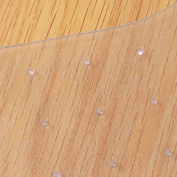 Clear chair mat with non-slip studs on wood floor