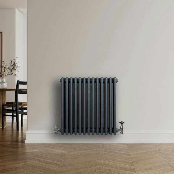 Traditional anthracite grey 4 column radiator with sleek vertical lines, mounted on a light wall, complementing modern decor