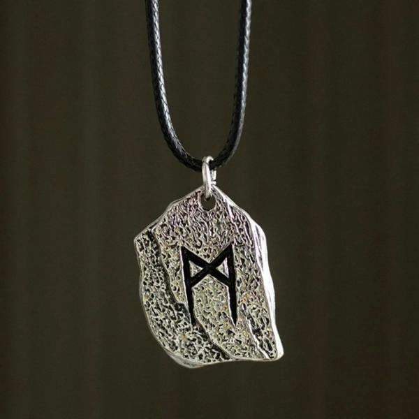 Silver rune shield pendant on black cord, textured metal with dark rune symbol.