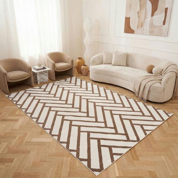 Living room with a geometric patterned rug, beige sofa, and armchairs.
