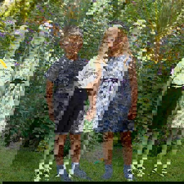 Boy wearing navy smocked set and girl wearing matching navy floral toile dress