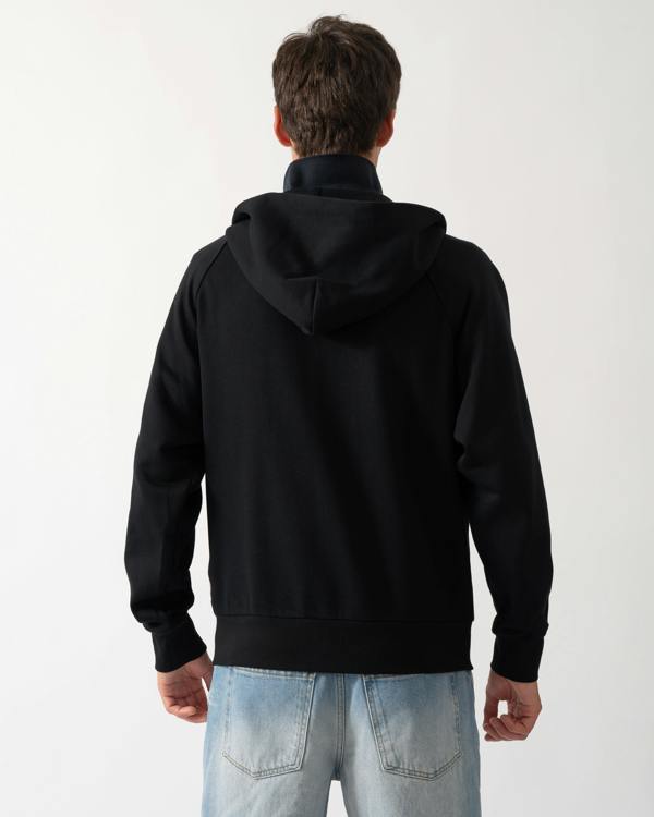 back of a a model wearing a Moose Knuckles Mens Yul Zip Up Hoodie in Black 292