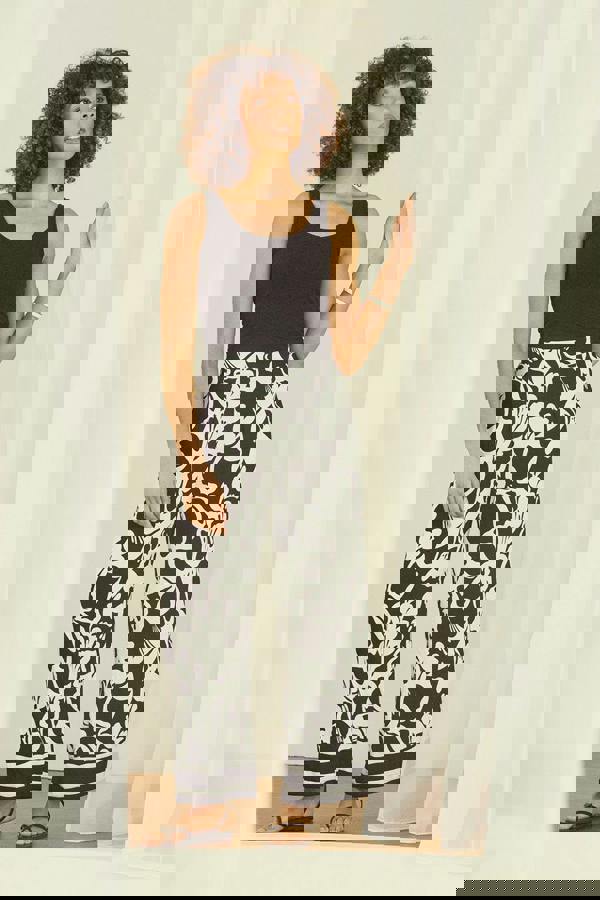 Black | Abstract Floral Wide Leg Trousers : Model is 5'8"/172 cm and wears UK8/EU36/US4/AUS8  