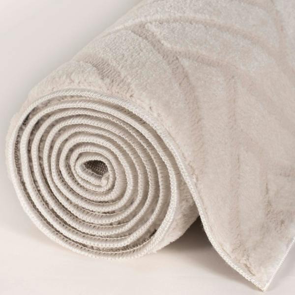 Rolled-up beige carpet on a light gray background
