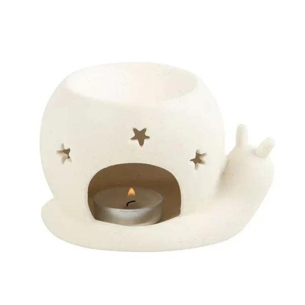 Cream snail oil burner with lit tealight candle and star accents