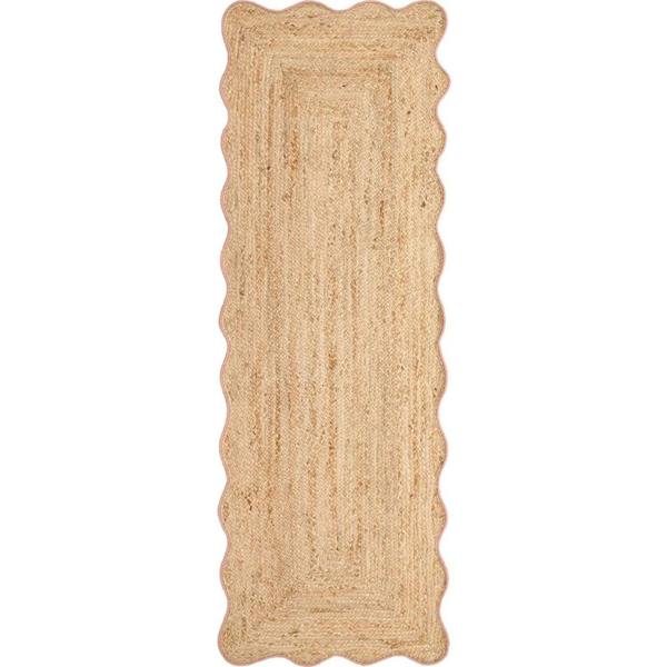 Beige braided rug with scalloped edges on a white background