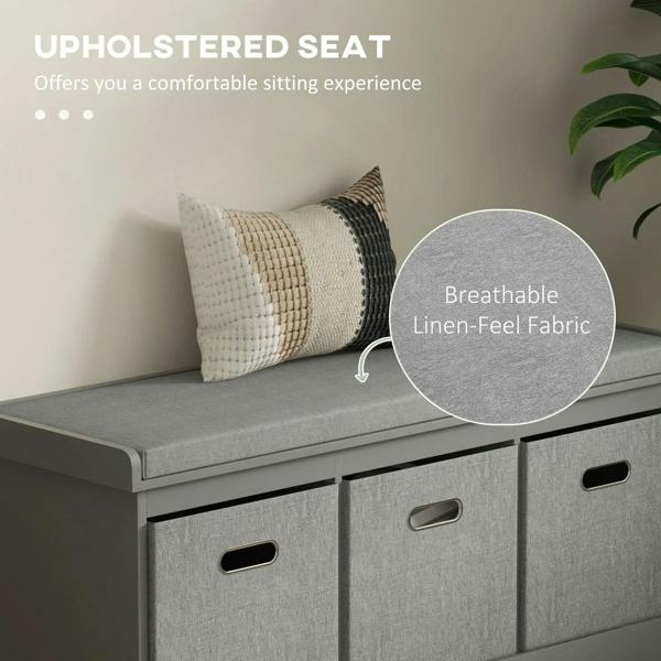 Grey shoe storage bench with padded seat and three fabric drawers