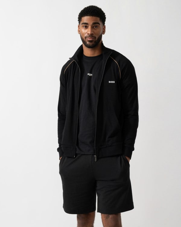 Model wearing a BOSS Orange Mix&Match Mens Logo-Embroidered Full Zip Loungewear Jacket in black Stretch-Cotton Jersey