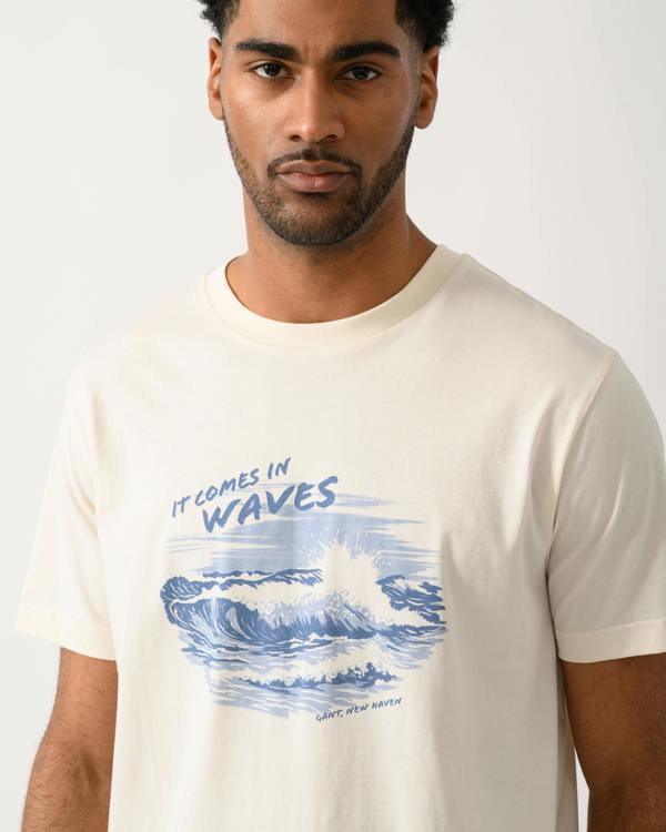 close up shot of a model wearing a GANT Mens Graphic Short Sleeve T-Shirt in 130 Cream