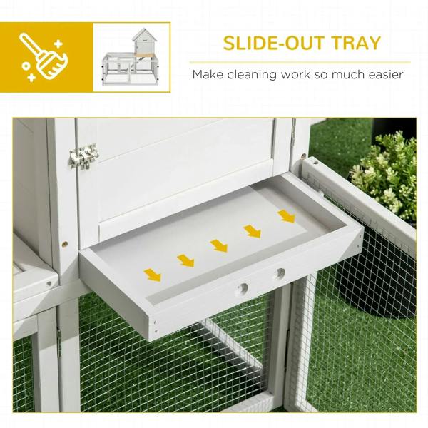 Slide-out cleaning tray on a light grey rabbit hutch, built into the lower area