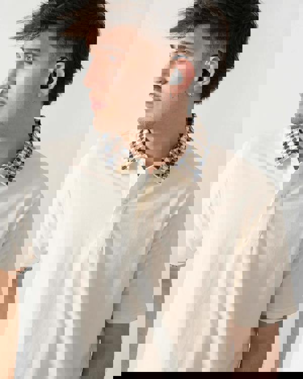 close up shot of model wearing an Aquascutum Mens Club Check Collar Polo Shirt in Old White 02