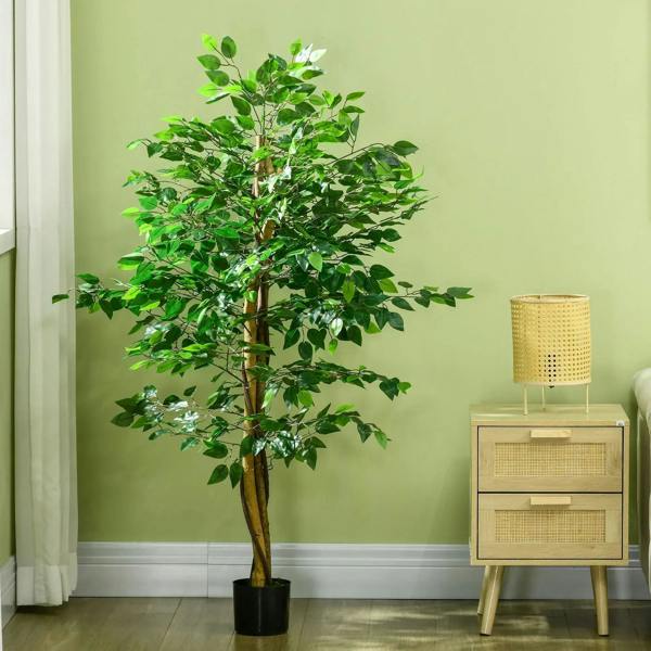 Green artificial ficus tree with dark pot and broad leafy canopy