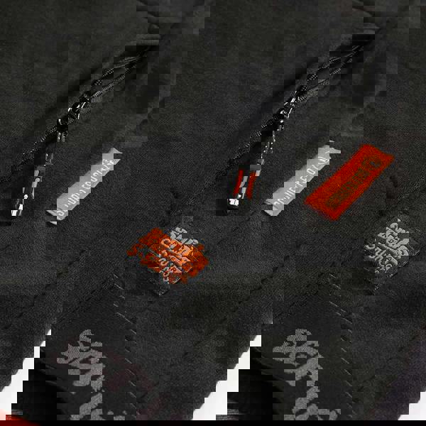 Scruffs Tech Men's Winter Warm Hooded Hoodie Sweatshirt, close-up image showing the black fabric, zipper pocket, and brand labels.