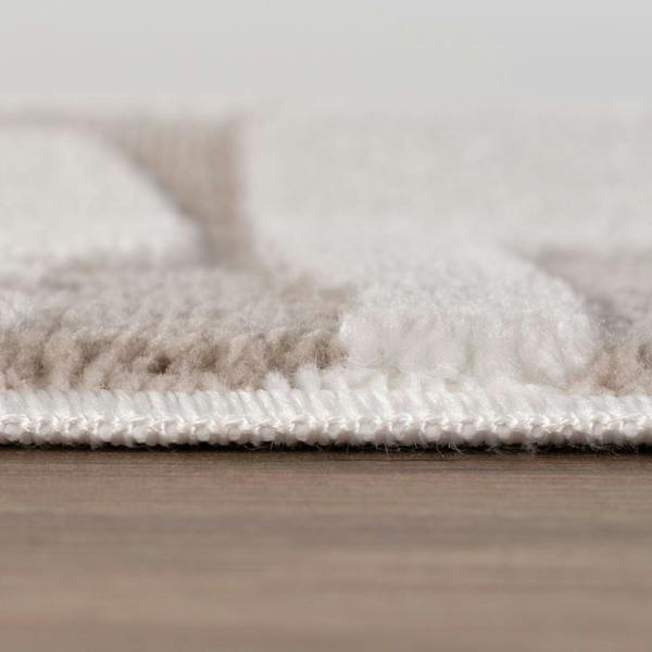 Close-up of a textured rug on a wooden floor