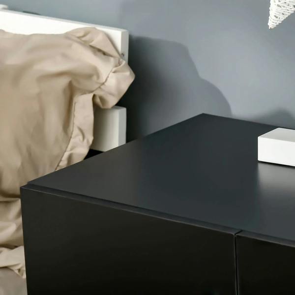 Close-up of black cabinet top and corner with smooth, flat finish