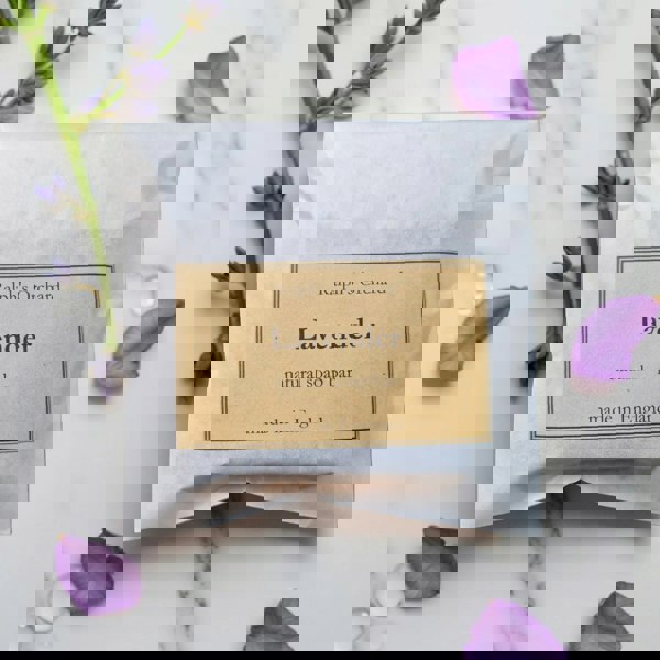 Lavender natural soap bar packaging with lavender flowers on a marble background