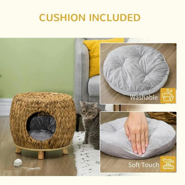 Grey round fabric cushion for a wicker cat bed, shown with handling