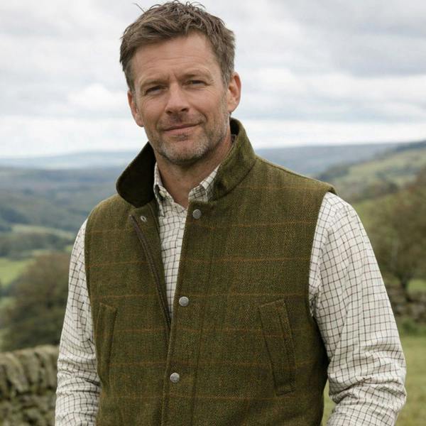 Man wearing the Game Ascot Men's Derby Tweed Gilet with checked country shirt, ideal for shooting, farming and country walks.