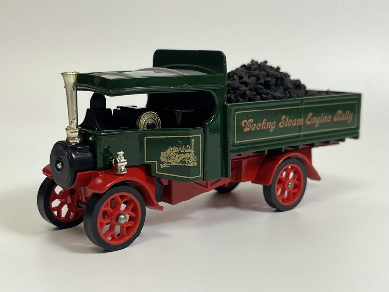 a toy truck with coal in the back