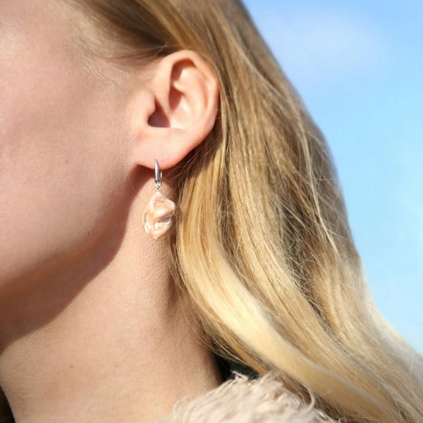 Natural shell drop earrings in salmon tone worn by a model. Stunning pink coral jewellery by LENAE London.