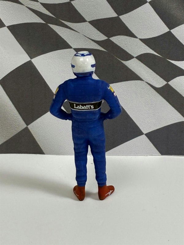 a toy figure of a man in a race suit