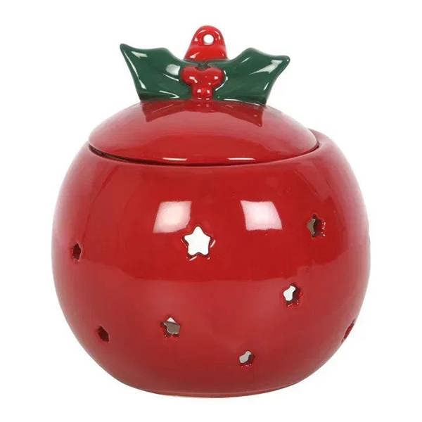 Red bauble oil burner with green holly cap and gold star cutouts.