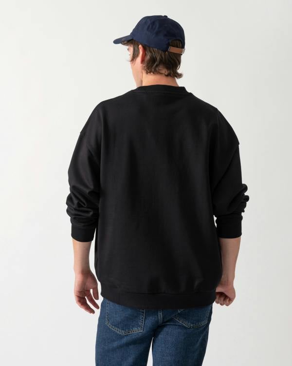 back shot of a model wearing a HUGO Dinex Mens Oversized-Fit Sweatshirt in Cotton Terry with Tonal Logo in Black 001