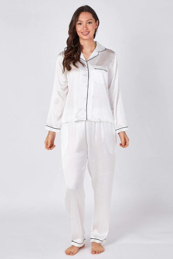 Woman wearing a white satin pajama set on a white background
