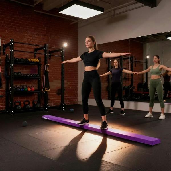 Purple folding balance beam for group training in a gym, padded non-slip top.