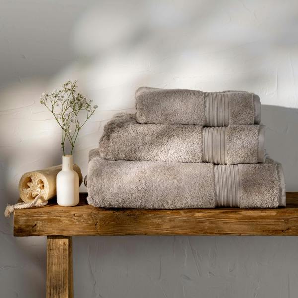 Taupe Egyptian Cotton Bath Towels styled in a bedroom | Soak and Sleep