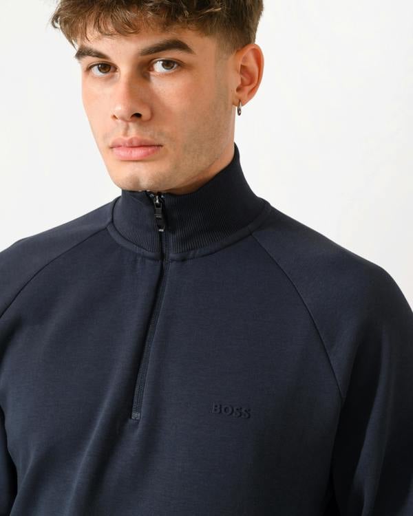 close up shot of a model wearing a BOSS Green Sweat Mens quarter Zip Sweatshirt in Dark Blue 402