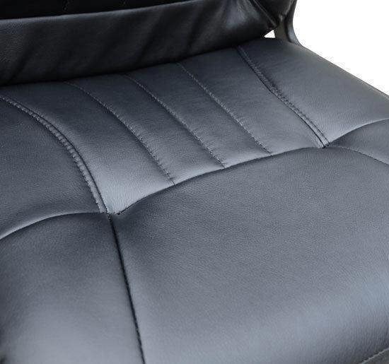Close-up of black PU leather chair seat with stitched cushion panels