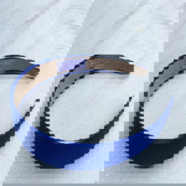 Royal blue hairband, smooth satin finish, bold deep blue shade, padded structure, sleek minimalist design, versatile fashion accessory
